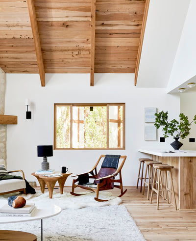 Bright light and airy living room with light wood flooring, white walls, Reclaimed oak cladded ceiling with beams. Natural wood grain.
