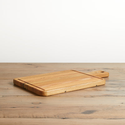 Reclaimed Oak rectangle cutting board with handle. Natural oak color with grain. Bevelled edge around board