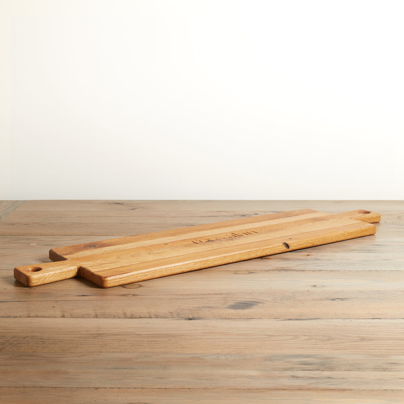 Long rectangle charcuterie board with handle on both ends. Relclaimed oak with natural color and wood grains.
