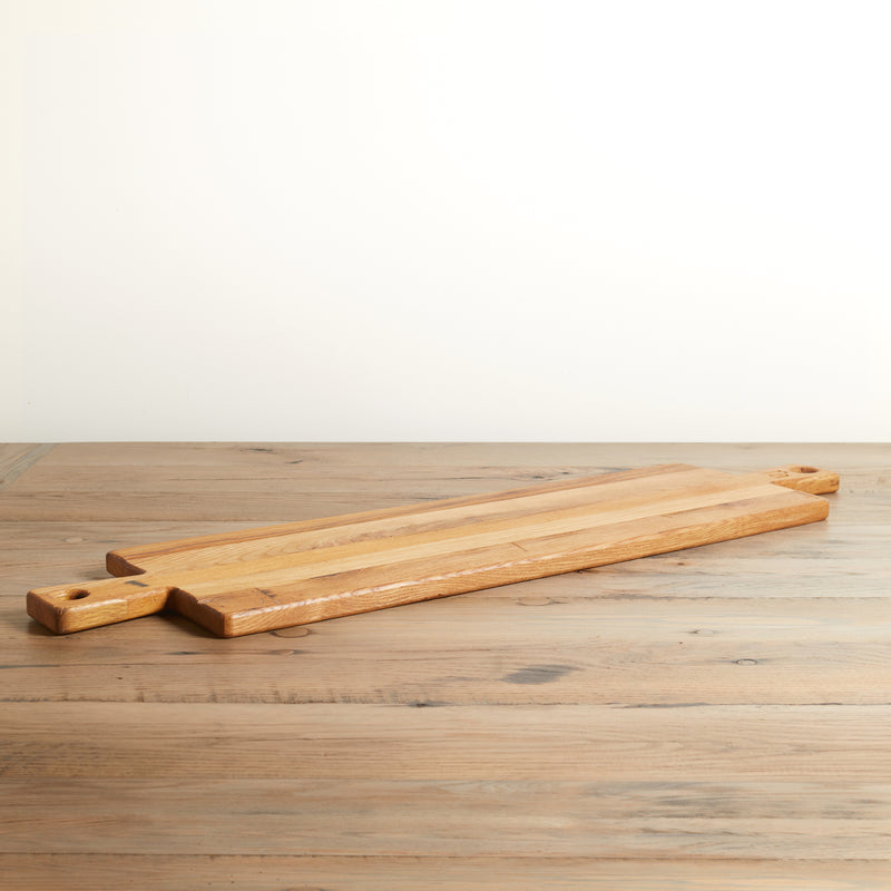 Long rectangle charcuterie board with handle on both ends. Relclaimed oak with natural color and wood grains.