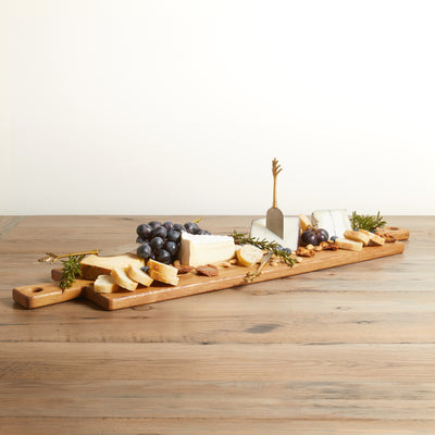 Long rectangle charcuterie board with handle on both ends. Relclaimed oak with natural color and wood grains. Shown with fruits and cheeses