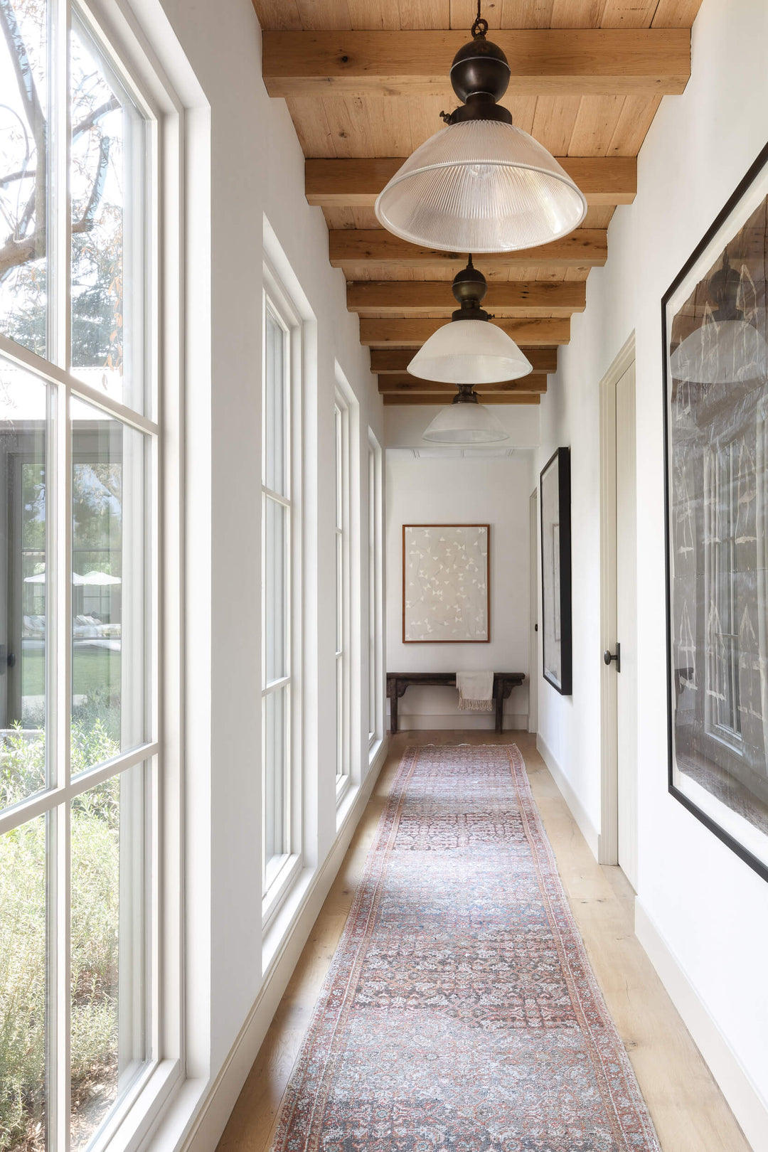 Amber Lewis Interiors hallway featuring white oak beams and t&g
