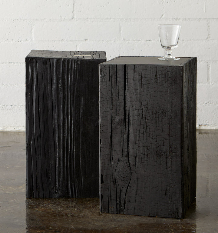 intense black city stump side tables propped